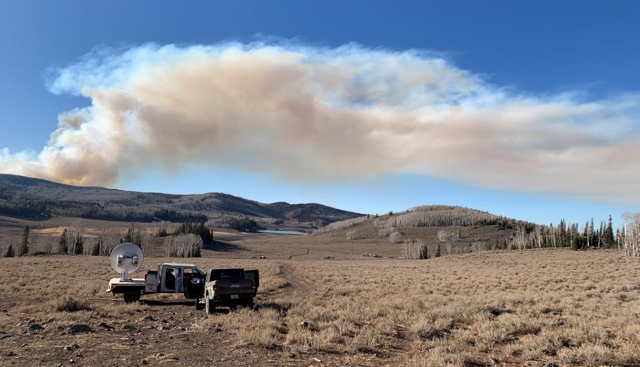 Smoke plume in the background from a prescribed, experimental burn in Fishlake National Forest, Utah. Foreground, truck-mounted mobile Ka-band polarized Doppler radar.