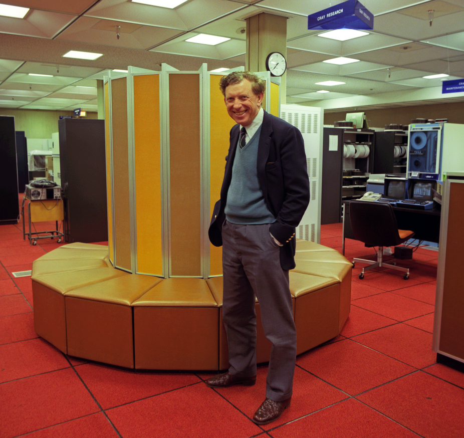 Walter Macintyre, who served as director of NCAR's Scientific Computing Division from 1980 to 1986, is shown here in front of the CRAY 1-A supercomputer.