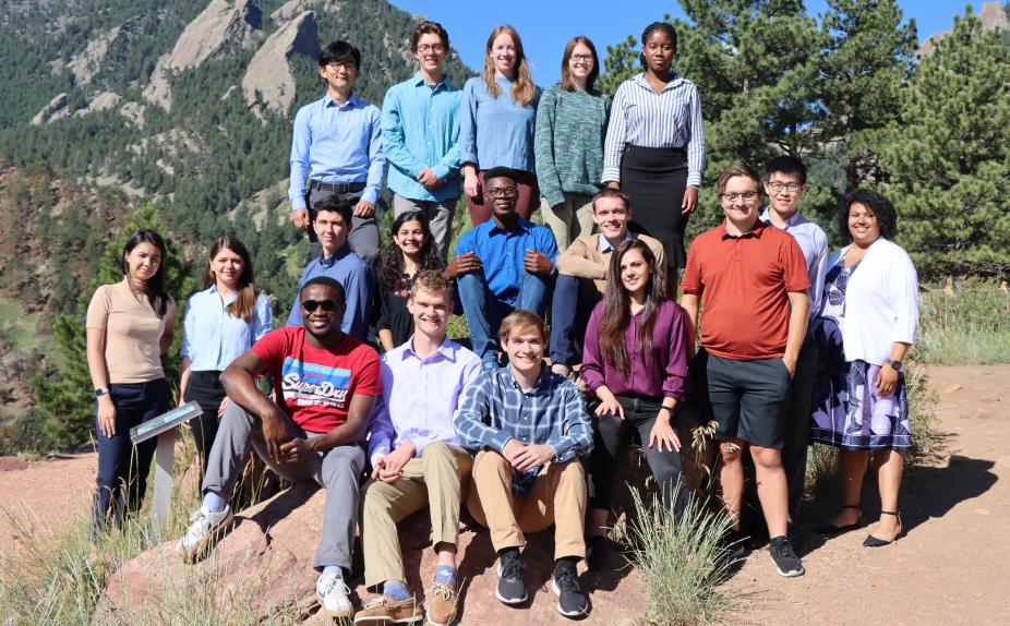 SIParCS interns in 2022 near the NCAR Mesa Lab in Boulder, Colorado. Trees and the Flatirons in the background.