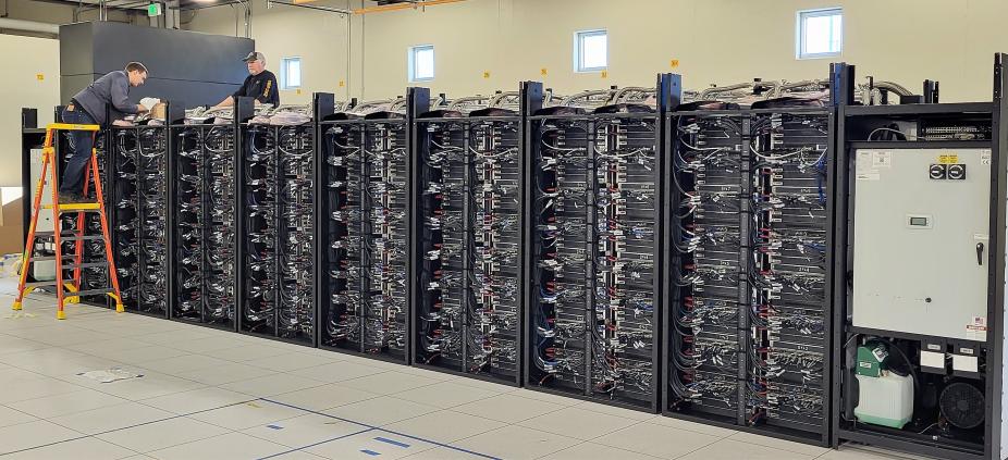 Workers installing supercomputer racks